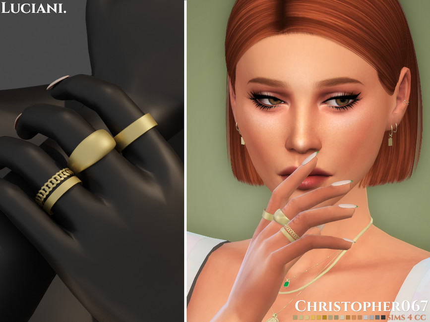 Un Sim con cabello corto y rojo y toneladas de joyas que lleva un juego de anillos dorados en su mano.